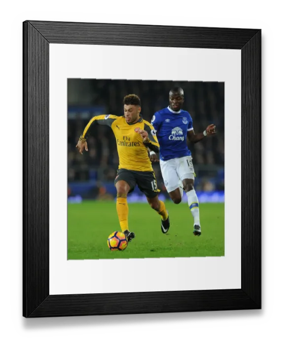 Framed Print : Arsenal's Oxlade-Chamberlain Clashes with Everton's Valencia in Premier League Showdown