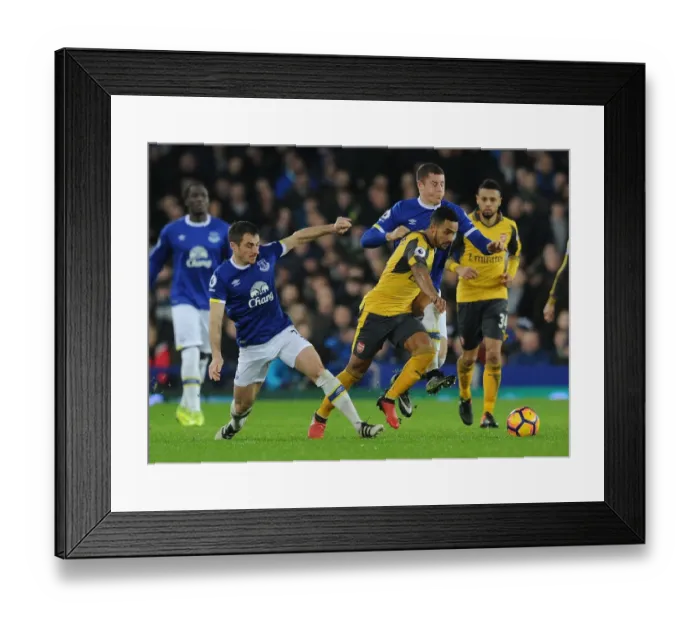 Framed Print : Theo Walcott Clashes with Everton's Leighton Baines and Ross Barkley during the Intense Everton vs Arsenal Premier League Match, 2016-17