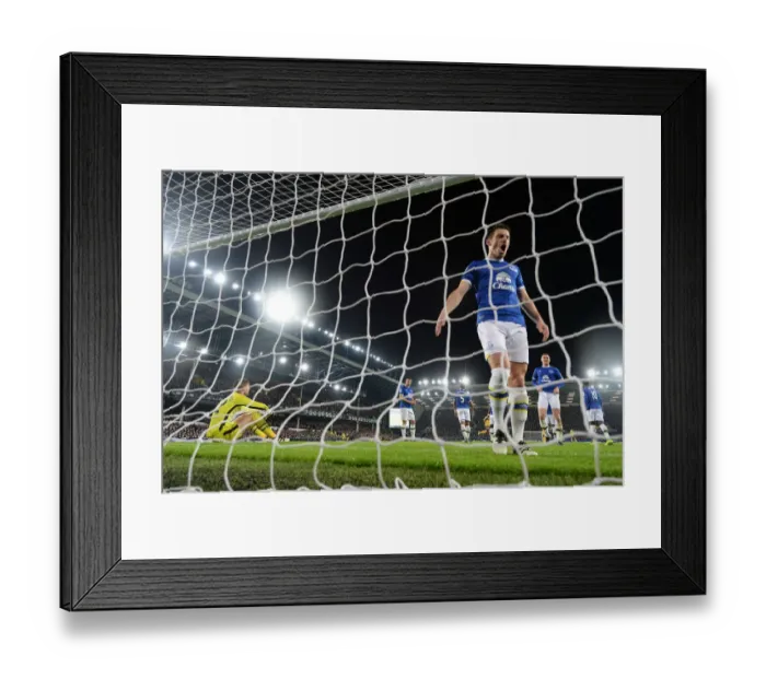 Framed Print : Everton's Disappointment: Arsenal Celebrate at Goodison Park