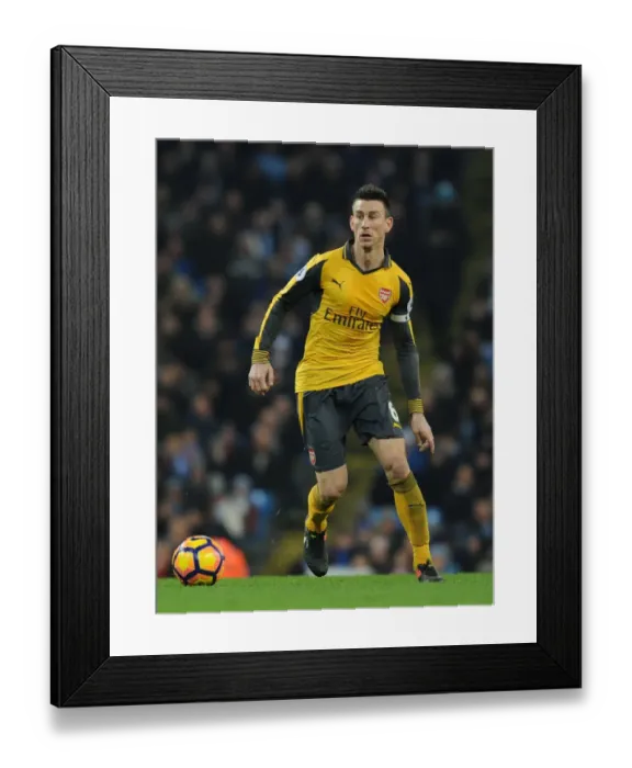 Framed Print : Laurent Koscielny Faces Manchester City: Arsenal vs. Manchester City, Premier League 2016-17 Framed Print : Laurent Koscielny Faces Manchester City: Arsenal vs. Manchester City, Premier League 2016-17