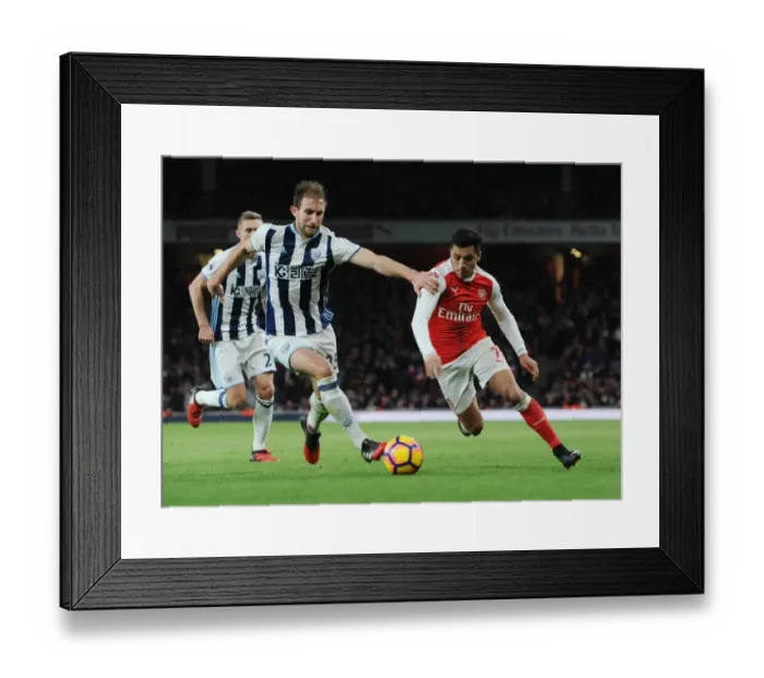 Framed Print : Arsenal's Alexis Sanchez Faces Off Against West Brom's Craig Dawson in Premier League Clash (December 2016)