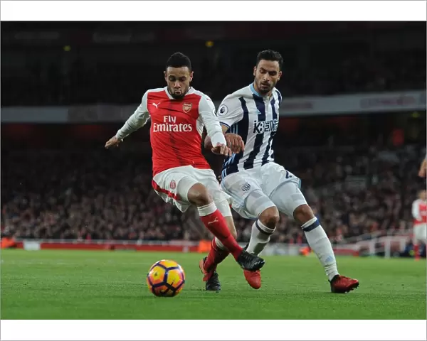 Arsenal's Francis Coquelin Fends Off West Brom's Nacer Chadli in Premier League Clash