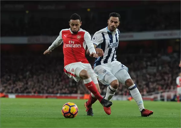 Arsenal's Francis Coquelin Fends Off West Brom's Nacer Chadli in Premier League Clash