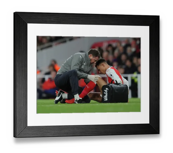 Framed Print : Arsenal's Kieran Gibbs Receives Treatment from Physio Colin Lewin during Arsenal v West Bromwich Albion Match Framed Print : Arsenal's Kieran Gibbs Receives Treatment from Physio Colin Lewin during Arsenal v West Bromwich Albion Match