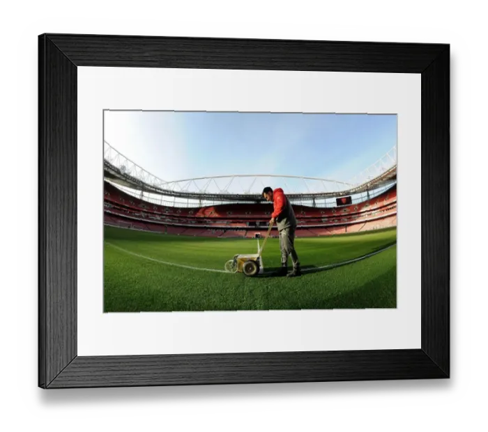 Framed Print : Arsenal Groundsman Prepares Emirates Stadium Pitch for Arsenal vs West Bromwich Albion (2016-17)