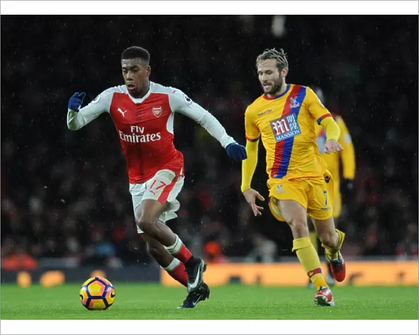 Arsenal's Alex Iwobi Outmaneuvers Crystal Palace's Yohan Cabaye during the 2016-17 Premier League Match