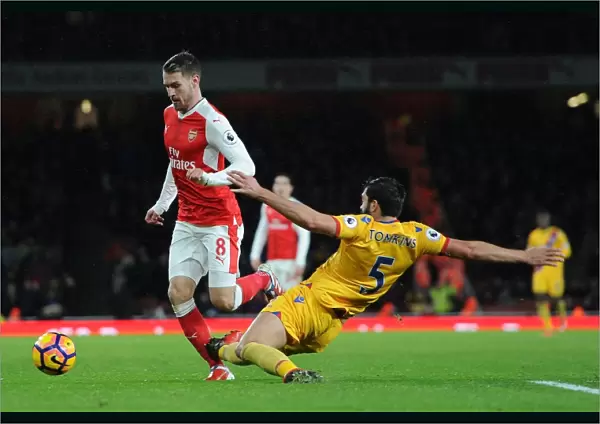 Arsenal's Aaron Ramsey Fouls by Crystal Palace's James Tomkins in Premier League Clash