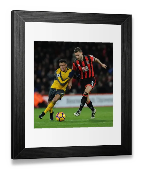 Framed Print : Intense Face-Off: Alexis Sanchez vs. Simon Francis in Premier League Battle