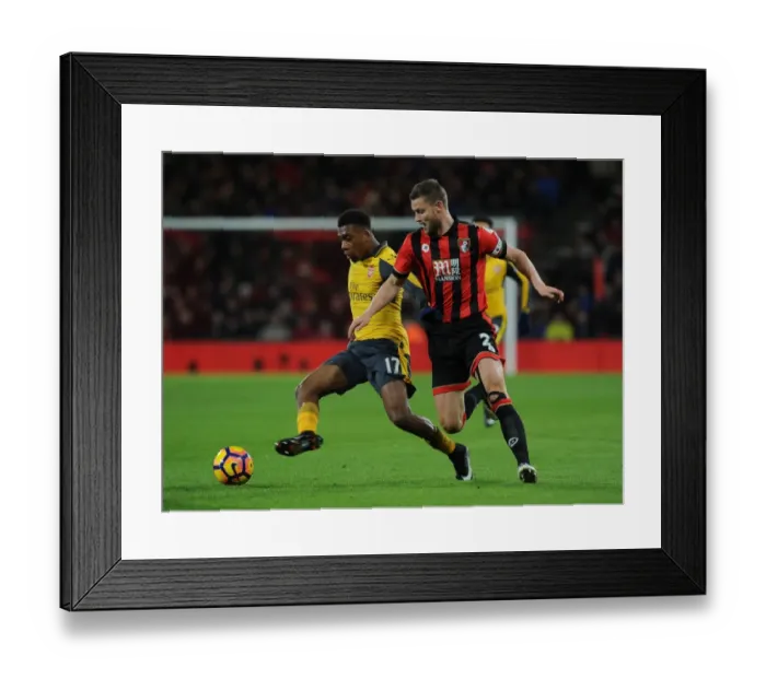 Framed Print : Arsenal's Alex Iwobi Faces Off Against Bournemouth's Simon Francis in Premier League Clash Framed Print : Arsenal's Alex Iwobi Faces Off Against Bournemouth's Simon Francis in Premier League Clash