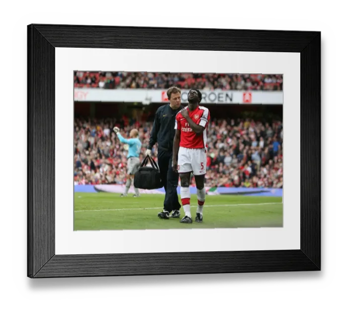 Framed Print : Arsenal physio Colin Lewin with injured Kolo Toure