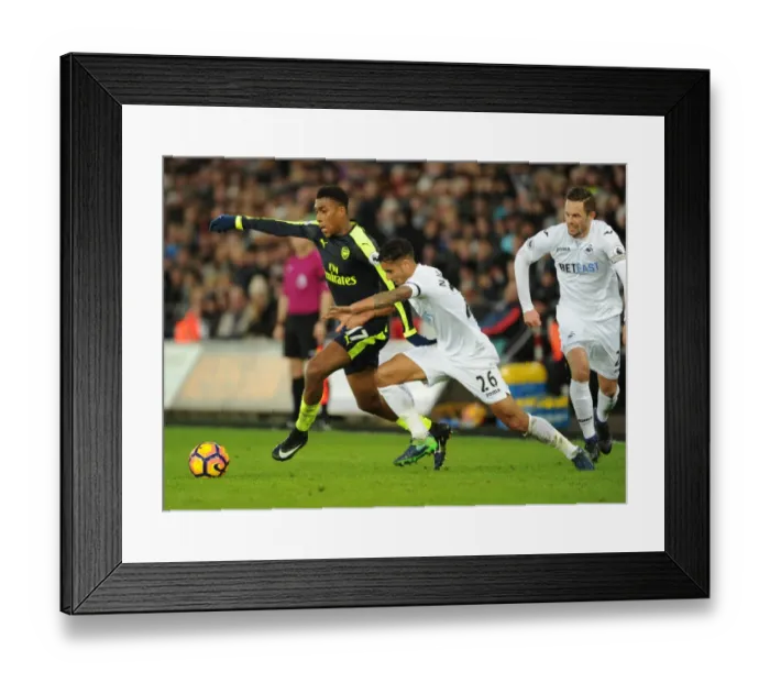 Framed Print : Arsenal's Alex Iwobi Faces Off Against Swansea's Kyle Naughton in Premier League Clash Framed Print : Arsenal's Alex Iwobi Faces Off Against Swansea's Kyle Naughton in Premier League Clash