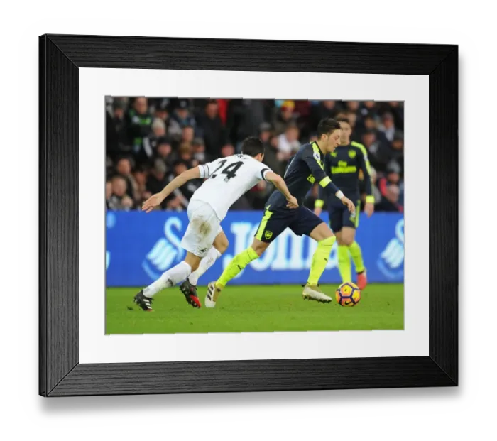 Framed Print : Mesut Ozil vs Jack Cork: A Premier League Battle at Swansea City Framed Print : Mesut Ozil vs Jack Cork: A Premier League Battle at Swansea City