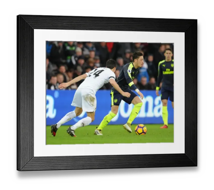 Framed Print : Mesut Ozil vs Jack Cork: A Premier League Showdown at Swansea City Framed Print : Mesut Ozil vs Jack Cork: A Premier League Showdown at Swansea City