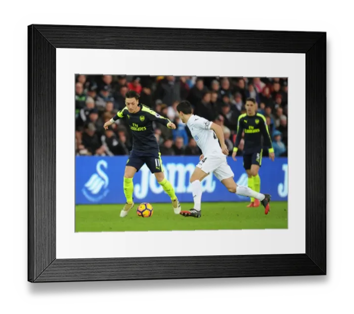 Framed Print : Mesut Ozil vs Jack Cork: A Premier League Showdown at Swansea City