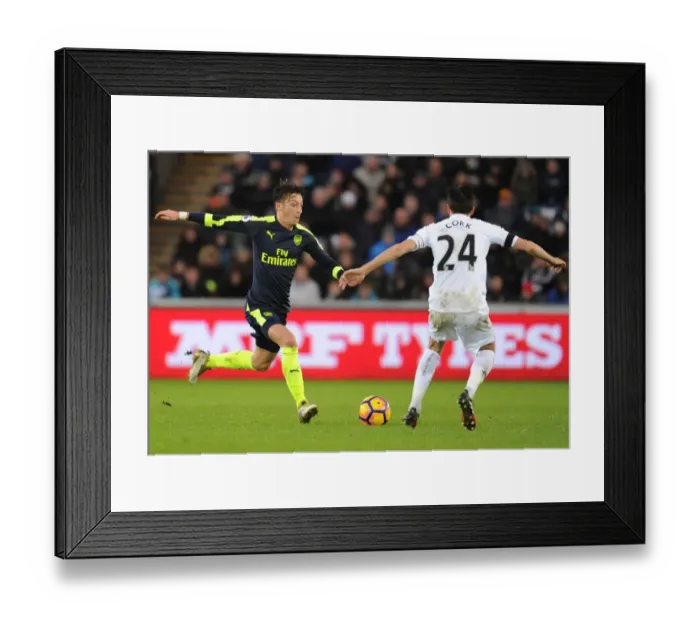 Framed Print : Mesut Ozil vs Jack Cork: Intense Battle in Swansea City vs Arsenal Premier League Clash Framed Print : Mesut Ozil vs Jack Cork: Intense Battle in Swansea City vs Arsenal Premier League Clash