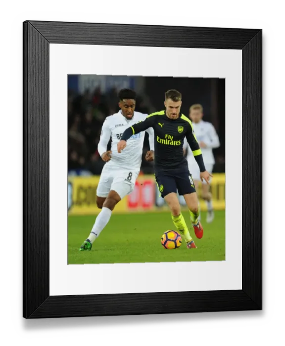 Framed Print : Arsenal's Aaron Ramsey Outwits Swansea's Leroy Fer in Thrilling Premier League Clash Framed Print : Arsenal's Aaron Ramsey Outwits Swansea's Leroy Fer in Thrilling Premier League Clash