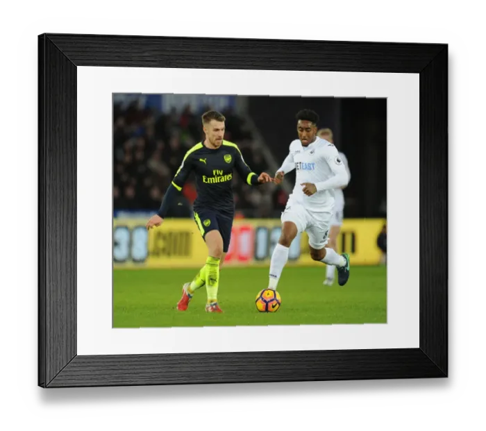 Framed Print : Arsenal's Aaron Ramsey Outmaneuvers Swansea's Leroy Fer in Premier League Clash Framed Print : Arsenal's Aaron Ramsey Outmaneuvers Swansea's Leroy Fer in Premier League Clash
