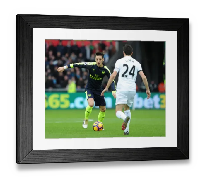 Framed Print : Mesut Ozil vs Jack Cork: A Premier League Showdown at Swansea City