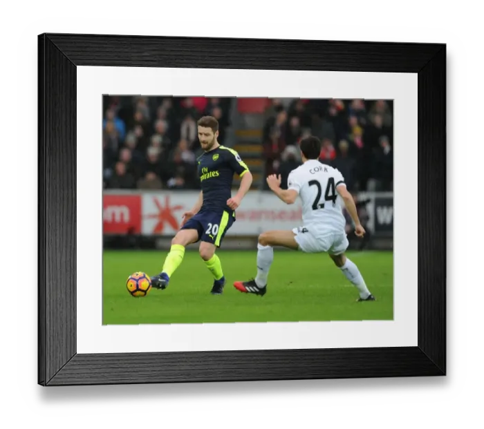 Framed Print : Mustafi vs Cork: Intense Battle in Swansea City vs Arsenal Premier League Clash Framed Print : Mustafi vs Cork: Intense Battle in Swansea City vs Arsenal Premier League Clash