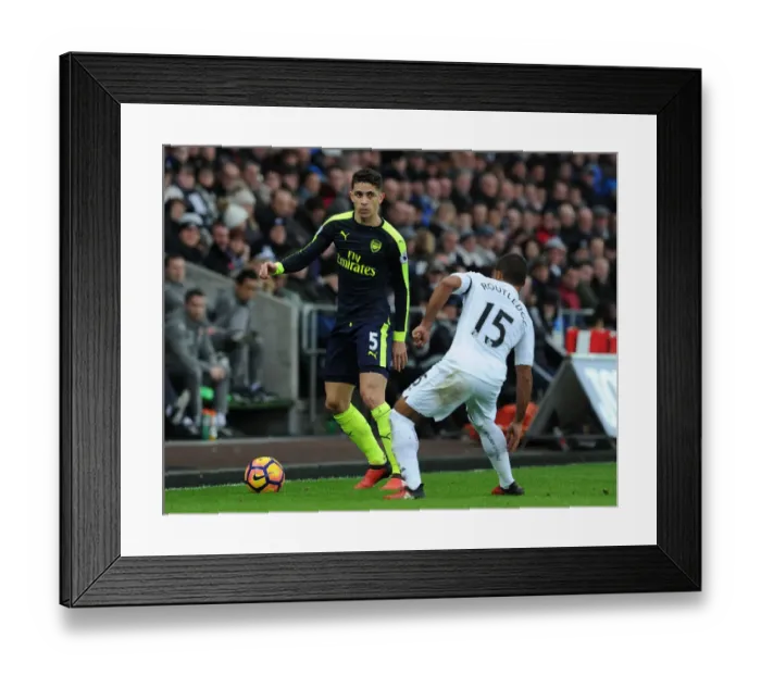 Framed Print : Gabriel vs Routledge: Intense Battle in Swansea City vs Arsenal Premier League Clash