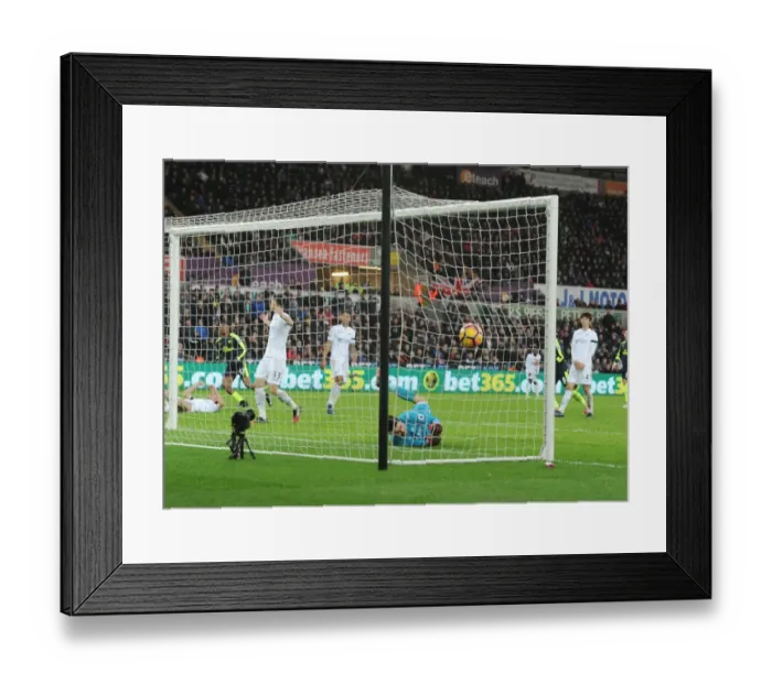 Framed Print : Arsenal's Iwobi Scores Deflected Goal Past Former Team-Mate Fabianski in Swansea Clash
