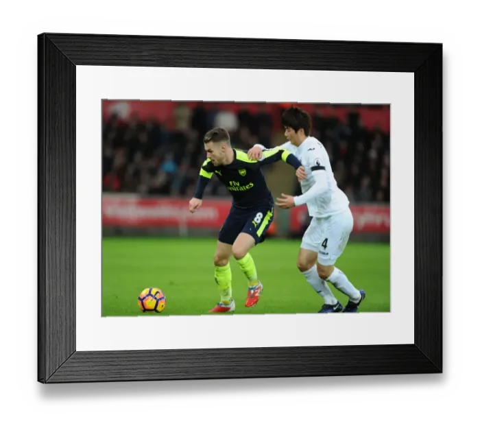 Framed Print : Ramsey vs. Ki: Intense Battle in Swansea City vs. Arsenal Premier League Clash Framed Print : Ramsey vs. Ki: Intense Battle in Swansea City vs. Arsenal Premier League Clash
