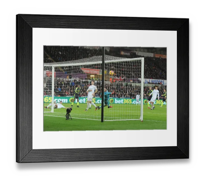 Framed Print : Iwobi Scores Deflected Goal Against Former Team-Mate Fabianski for Arsenal at Swansea