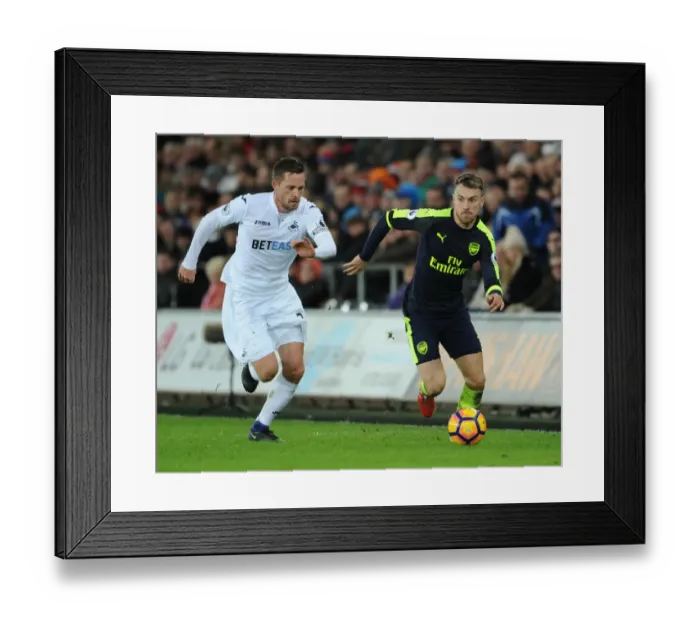 Framed Print : Arsenal's Aaron Ramsey Outwits Swansea's Sigurdsson: Intense Premier League Battle Framed Print : Arsenal's Aaron Ramsey Outwits Swansea's Sigurdsson: Intense Premier League Battle
