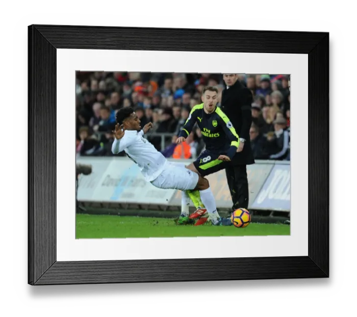 Framed Print : Ramsey vs. Fer: Intense Battle in Swansea City vs. Arsenal Premier League Clash