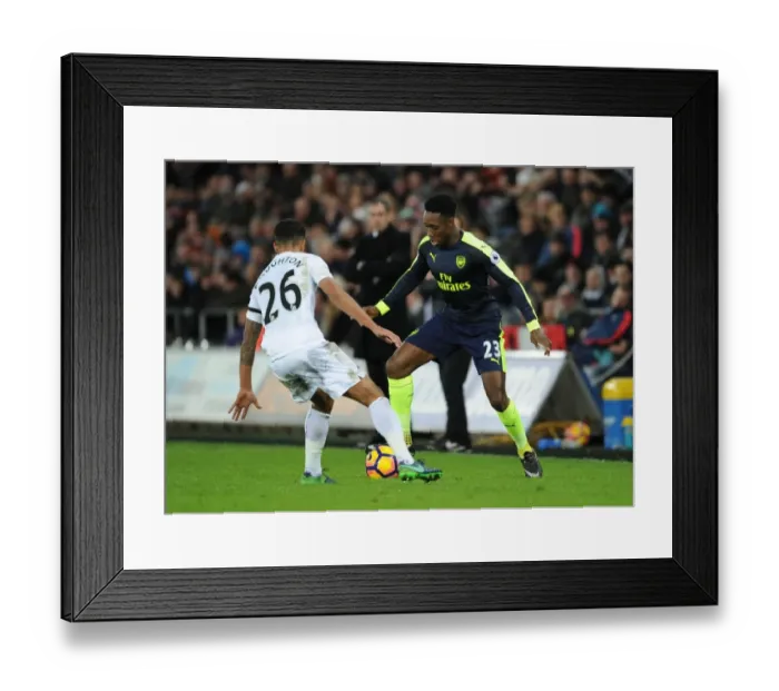 Framed Print : Welbeck vs Naughton: Intense Battle in Swansea City vs Arsenal Premier League Clash