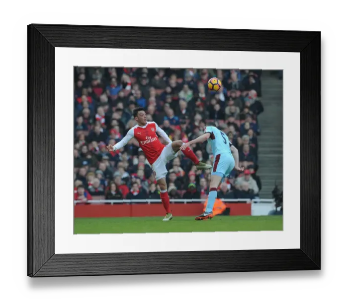 Framed Print : Arsenal's Ozil Outmaneuvers Burnley's Keane in Premier League Clash