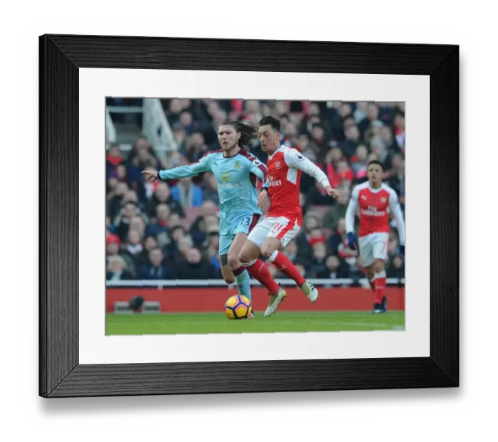 Framed Print : Arsenal vs Burnley: Mesut Ozil Faces Off Against Jeff Hendrick