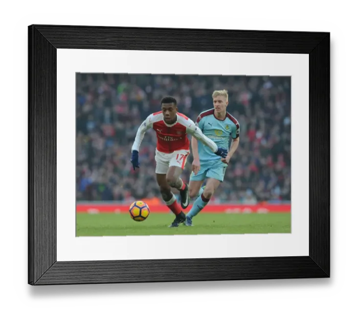 Framed Print : Arsenal's Alex Iwobi Faces Off Against Burnley's Ben Mee in Premier League Clash