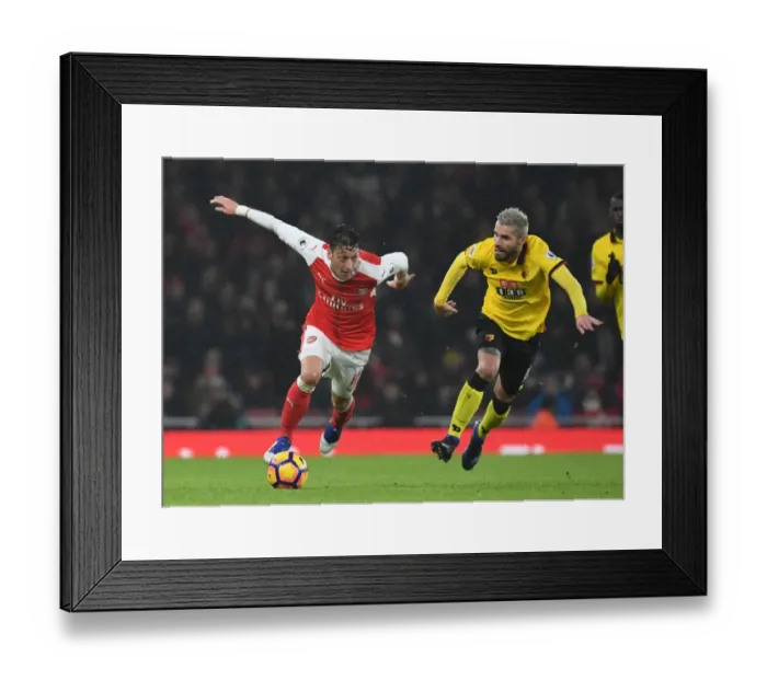 Framed Print : Arsenal's Ozil Outmaneuvers Watford's Behrami in Premier League Clash Framed Print : Arsenal's Ozil Outmaneuvers Watford's Behrami in Premier League Clash