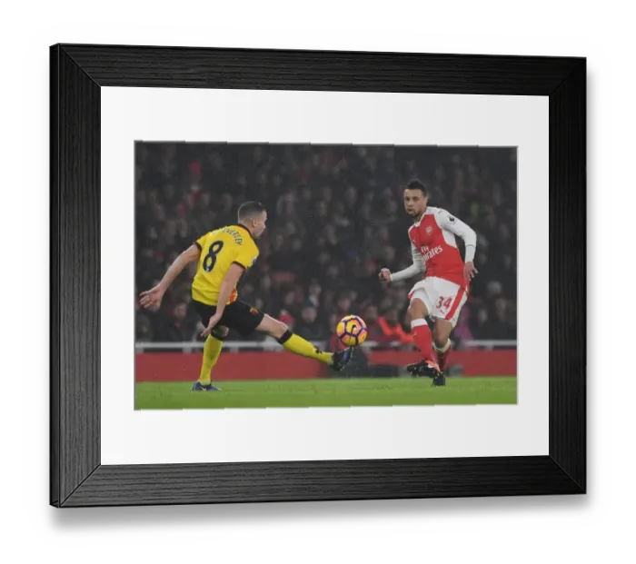 Framed Print : Arsenal vs. Watford: Coquelin Evades Cleverley's Pressure in Premier League Clash Framed Print : Arsenal vs. Watford: Coquelin Evades Cleverley's Pressure in Premier League Clash