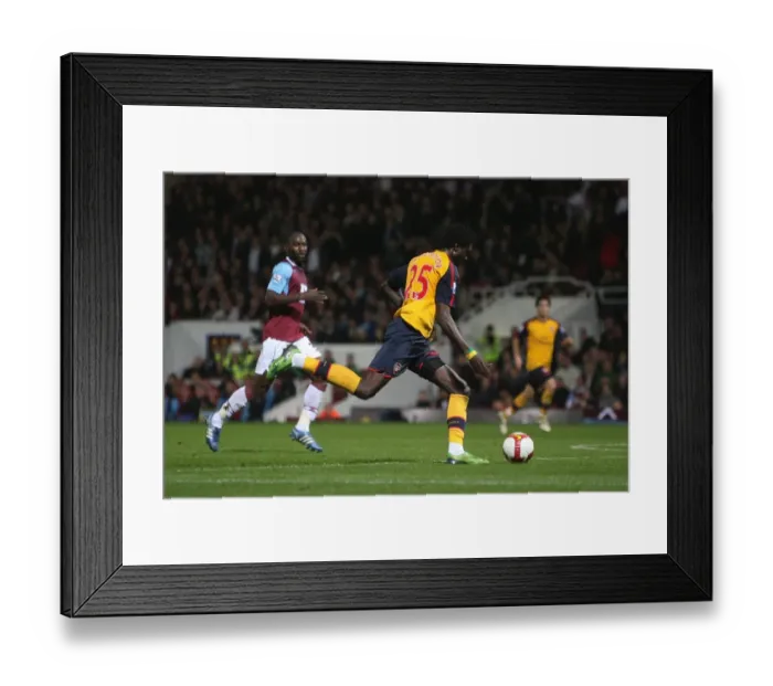 Framed Print : Emmanuel Adebayor shoots past Herita Ilunga to score Framed Print : Emmanuel Adebayor shoots past Herita Ilunga to score