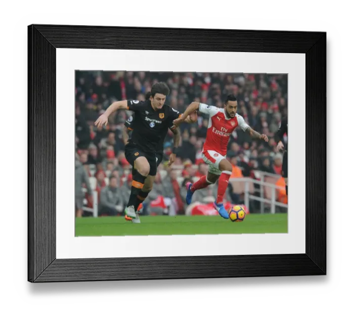 Framed Print : Arsenal's Theo Walcott Clashes with Hull's Harry Maguire in Premier League Showdown