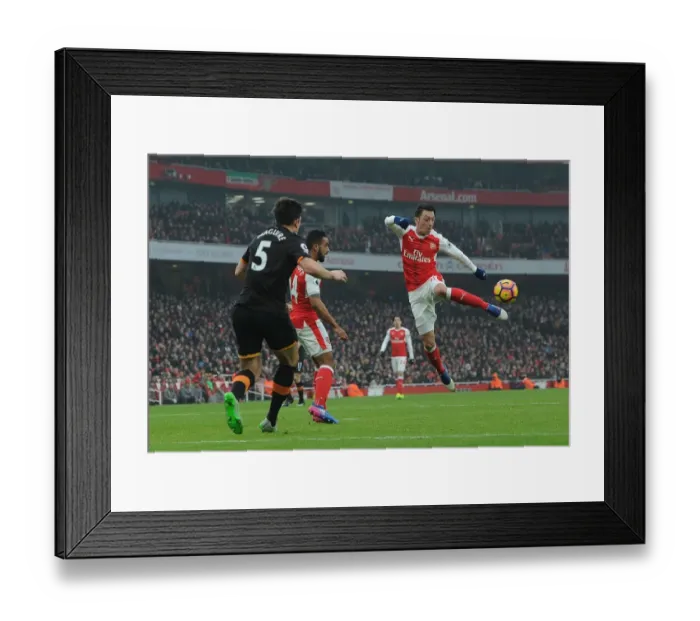 Framed Print : Mesut Ozil Faces Off Against Harry Maguire: Arsenal vs Hull City, Premier League 2016-17