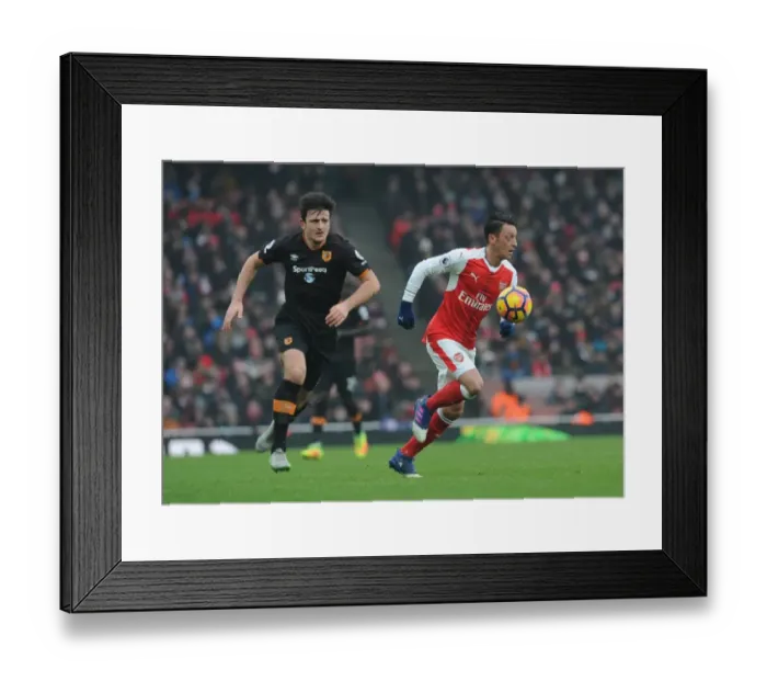 Framed Print : Arsenal's Ozil Clashes with Hull's Maguire in Premier League Showdown