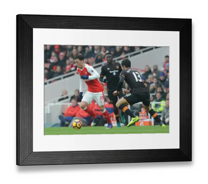 Framed Print : Arsenal's Mesut Ozil Faces Off Against Hull City's Andrea Ranocchia in Premier League Clash Framed Print : Arsenal's Mesut Ozil Faces Off Against Hull City's Andrea Ranocchia in Premier League Clash
