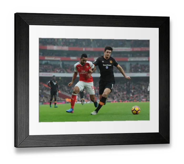 Framed Print : Arsenal's Theo Walcott Faces Off Against Hull's Harry Maguire in Premier League Clash Framed Print : Arsenal's Theo Walcott Faces Off Against Hull's Harry Maguire in Premier League Clash