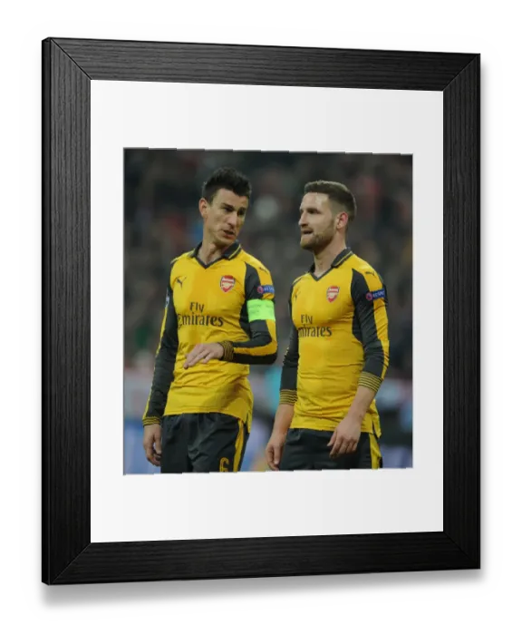 Framed Print : Arsenal's Koscielny and Mustafi Face Off Against Bayern Munich in Champions League Showdown Framed Print : Arsenal's Koscielny and Mustafi Face Off Against Bayern Munich in Champions League Showdown