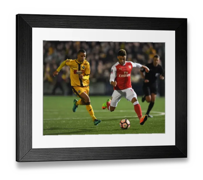 Framed Print : Arsenal's Oxlade-Chamberlain Faces Off Against Sutton's Eastmond: The FA Cup Shock Encounter Framed Print : Arsenal's Oxlade-Chamberlain Faces Off Against Sutton's Eastmond: The FA Cup Shock Encounter