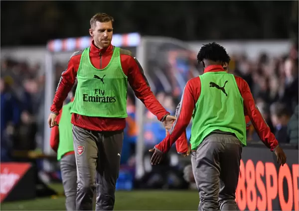 Arsenal's Unforgettable FA Cup Encounter: Per Mertesacker and Ainsley Maitland-Niles High-Five at Sutton United