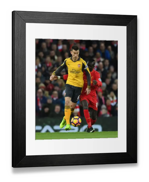 Framed Print : Koscielny vs Mane: Intense Battle at Anfield - Liverpool vs Arsenal, Premier League 2016-17