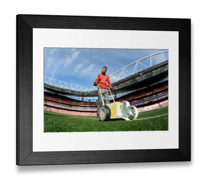 Framed Print : Preparing the Emirates Turf: Arsenal FC vs. FC Bayern Munich - UEFA Champions League Showdown