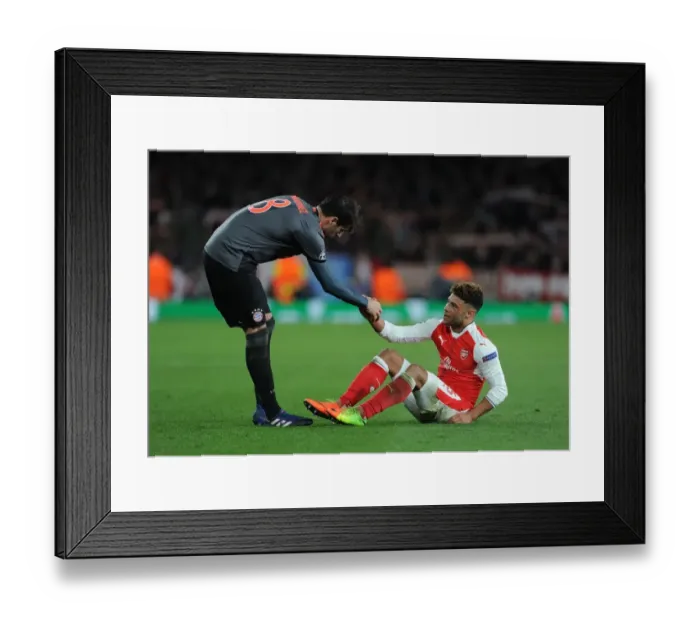 Framed Print : Arsenal's Oxlade-Chamberlain Consoled by Bayern's Javi Martinez in UEFA Champions League Clash