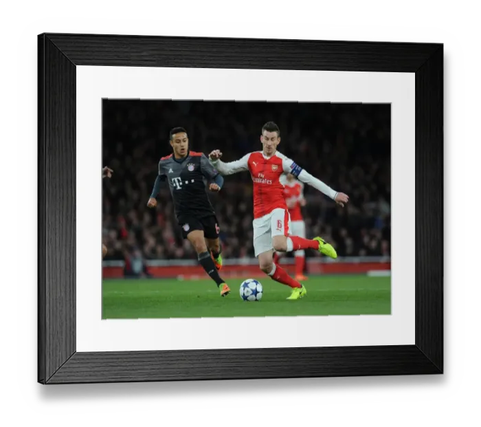 Framed Print : Battle of Midfield Titans: Koscielny vs Thiago in Arsenal vs Bayern Munich Champions League Showdown Framed Print : Battle of Midfield Titans: Koscielny vs Thiago in Arsenal vs Bayern Munich Champions League Showdown