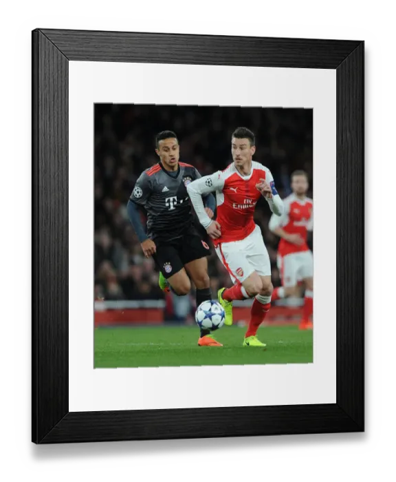 Framed Print : Arsenal vs. Bayern Munich: Laurent Koscielny vs. Thiago Alcantara - UEFA Champions League Showdown