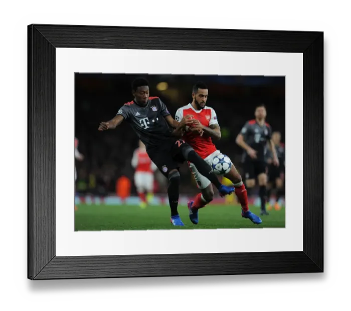 Framed Print : Theo Walcott vs. David Alaba: A Champions League Battle at the Emirates